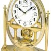 Rhythm Pendule à Poser Dorée Sur Socle En Plastique